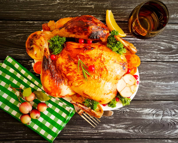 istock whole fried chicken, garlic on wooden background 1098341148