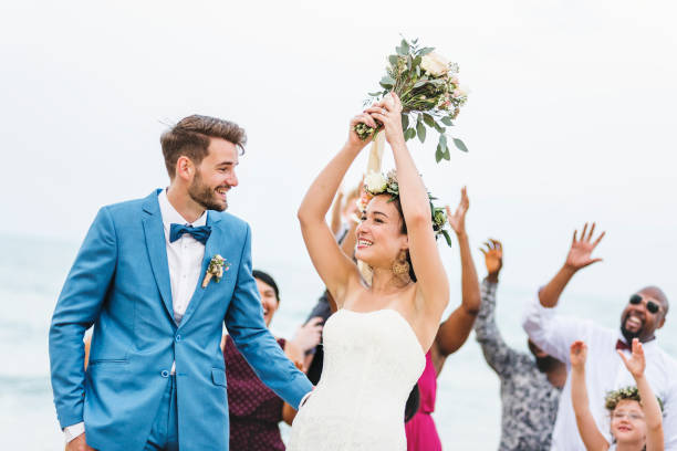 istock Bride throwing flower bouquet to guests 1098344974