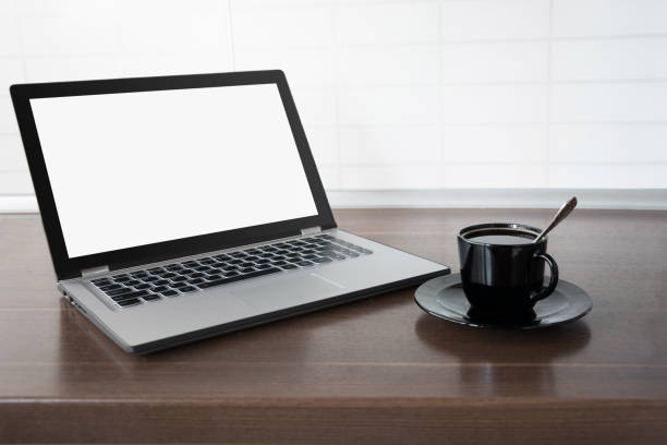 istock Laptop with empty blank screen on wooden tabletop with modern blur kitchen background. Work at home. 1098345852