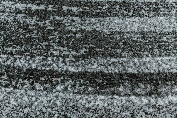 istock Ice and snow covered road surface on a cold winters day. Dangerous road conditions. 1098345878