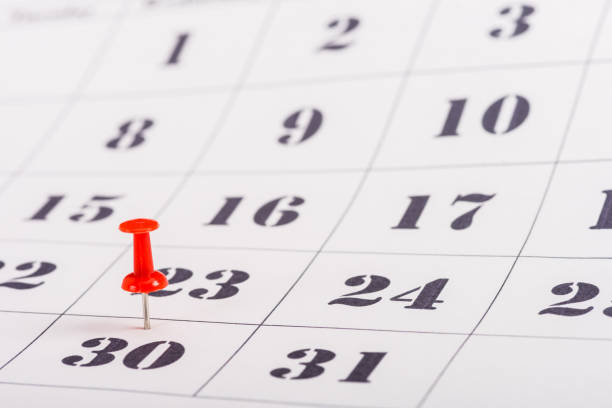 istock selective focus of red pin on number 30 in calendar 1098347804