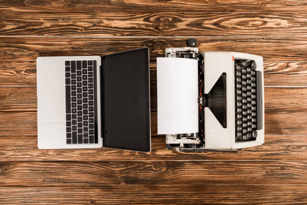 istock top view of typewriter and laptop on wooden table 1098347848