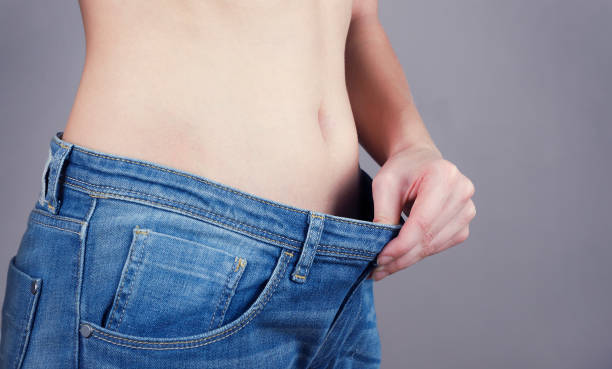istock Big size jeans on slim girl, close up. 1098348486