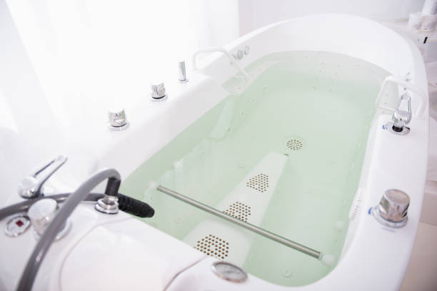 istock Hydro massage bath full of water in modern spa salon 1098349792