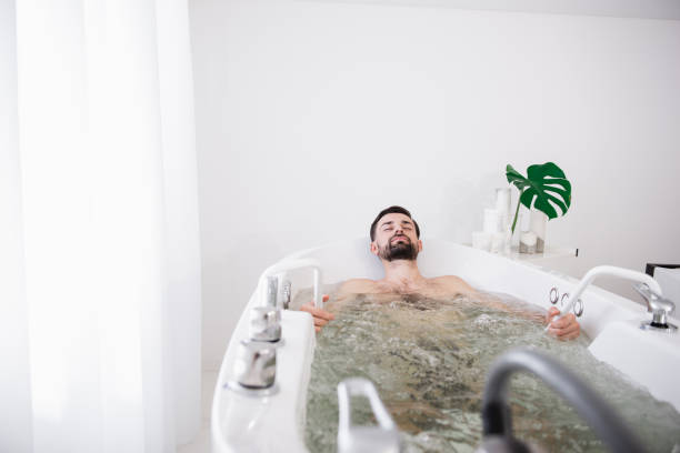 istock Peaceful bearded man enjoying sitting in hydro massage bathtub 1098349828
