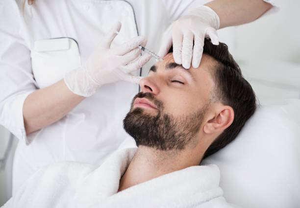 istock Calm man closing his eyes during the beauty injection procedure 1098349880