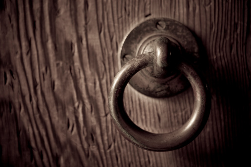 A stock photo of an ancient Japanese door knob on the gate of the Meiji Temple in Tokyo Japan.