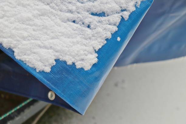 istock Bright blue tarpaulin under snow. Waterproof surface. 1098355764