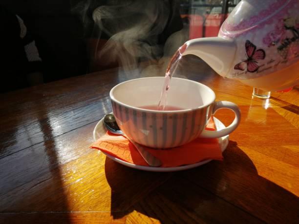 istock Cup of fruit tea with teapot 1098358606