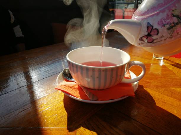 istock Cup of fruit tea with teapot 1098358650