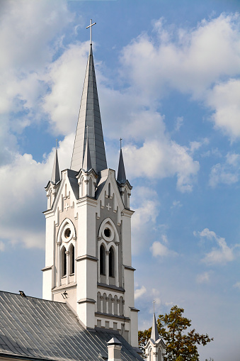 Towers and crosses on roof of Lutheran Church of St. John monument of 18th century architecture neo-Gothic style in European city Grodno or Hrodna visa free center of Belarus with copy space.