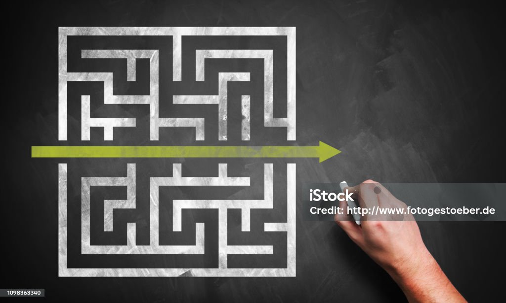 hand drawing a shortcut to a maze on a chalkboard Efficiency Stock Photo