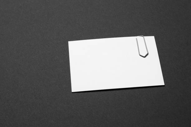 istock business card empty with paper clip on dark grey background 1098364588