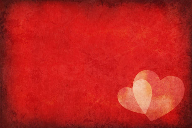 Vector illustration of two overlapping hearts over a dark red grunge old Background with copy space for text Dark red color grungy old starry Background with two overlapping pale smudged hearts. Shade and tone of the hearts is pale yellowish with slightly lighter at the intersection.Can be used as greeting card, postcard, love note, letter pad, poster, background, wallpaper or gift wrapping paper sheet. Valentine / Valentine's Day, happy festive background. No text. No people. Grungy. Vignetting, abrasive sandpaper effect. New Year, Christmas festive theme bright colour. Dark, almost black tint in corners and edge. Bright middle. Color gradient. Cracked or stained glow in the dark hearts background stock illustrations
