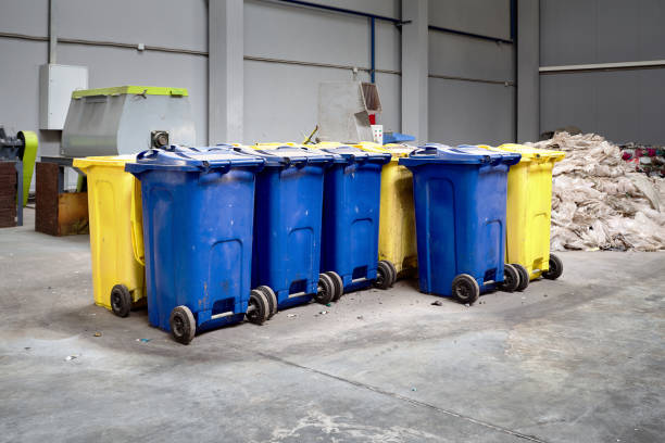 istock Containers with shredded plastic prepared for further processing remelting and recycling with shredder in background. 1098365060