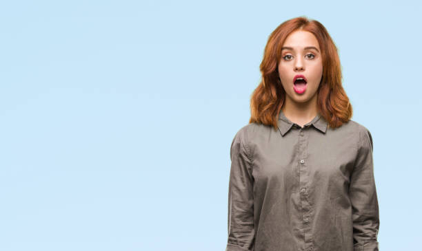 istock Young beautiful woman over isolated background afraid and shocked with surprise expression, fear and excited face. 1098366282