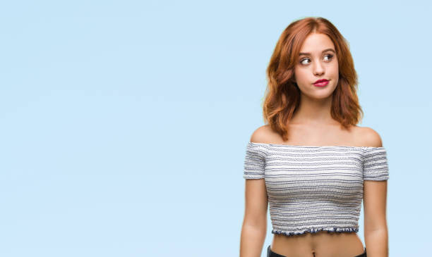 istock Young beautiful woman over isolated background smiling looking side and staring away thinking. 1098368352