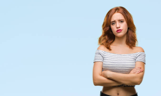istock Young beautiful woman over isolated background skeptic and nervous, disapproving expression on face with crossed arms. Negative person. 1098368380