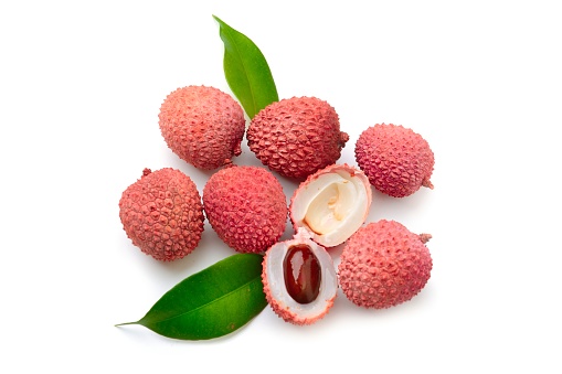 There are some lychees on the wooden table top