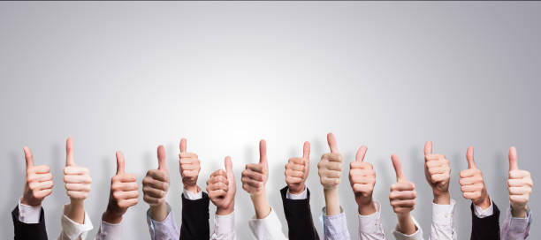istock many thumbs up in front of a grey background 1098369698