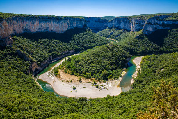 The Famous Bend of the Ardeche River in Gorges de l'Ardeche, South-Central France The famous bend of the Ardeche River in Gorges de l'Ardeche, South-Central France ravine stock pictures, royalty-free photos & images