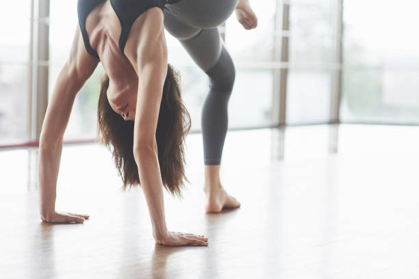 istock A beautiful yoga woman practicing in a spacious light gym 1098372394