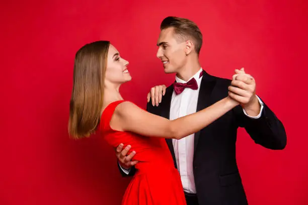 Portrait of his he her she two nice sweet tender lovely attractive imposing charming cheerful affectionate people dancing isolated over bright vivid shine red background