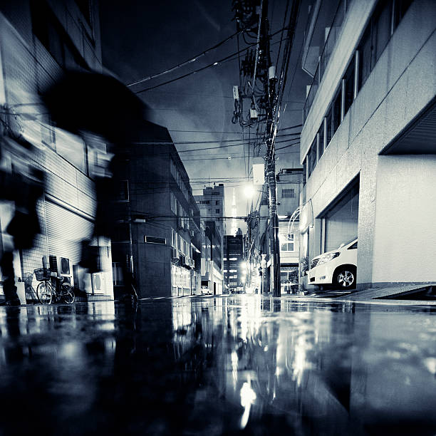 rainy night in big city rainy night in big city, people with umbrellas. low angle street japan stock pictures, royalty-free photos & images