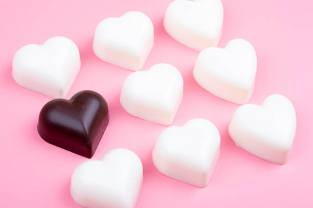 istock white and black heart chocolate on colored background 1098377006