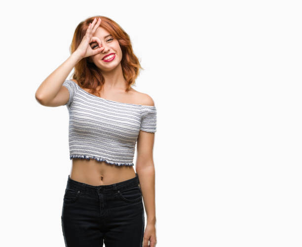 istock Young beautiful woman over isolated background doing ok gesture with hand smiling, eye looking through fingers with happy face. 1098377670