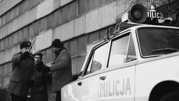 Photo of Polish martial law 1981. Socialist militia patrol staring a chase