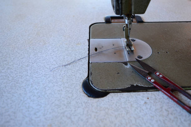 istock the old scissor ,blue thread in presser foot on panel of old sewing machine 1098382170