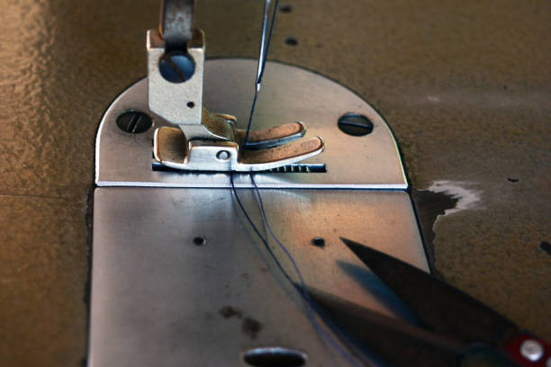 istock the old scissor ,blue thread in presser foot on panel of old sewing machine 1098382364