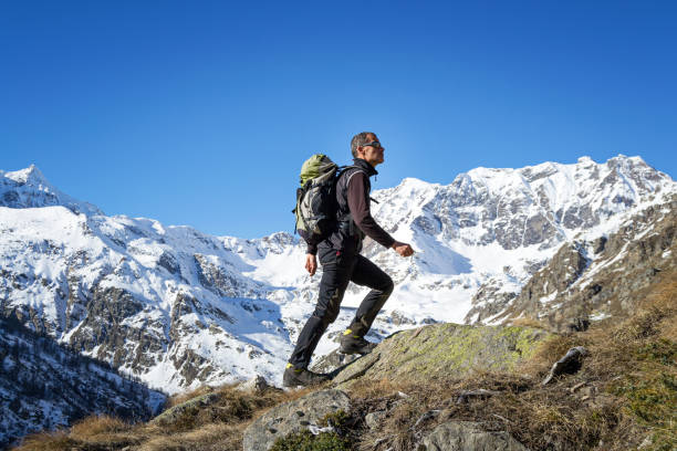 Man trekking in the Alps. Grand Paradiso National Park. Italy stock photo