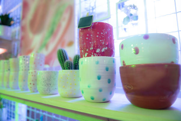 istock Unusual dotted pots placed in range on wooden shelve 1098386062