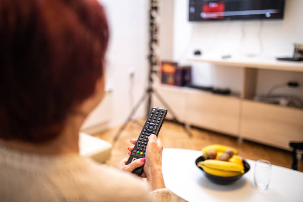 Senior woman Changing channels on TV