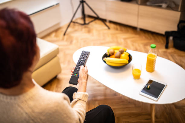Senior woman Changing channels on TV