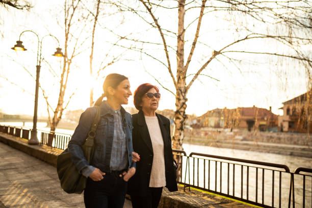 istock Young woman taking a walk with granny 1098386964