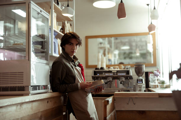 istock Appealing young man with old-fashioned hairstyle carrying hardcover book 1098387550