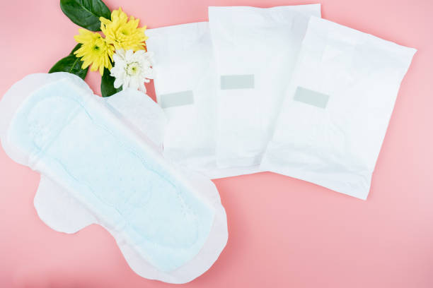 Sanitary pads and absorbent sheets on a pink background stock photo