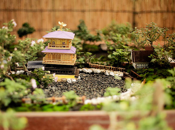 A miniature Japanese building and bonsai tree garden.