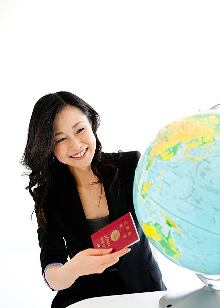 Woman choosing travel destination on the globe stock photo