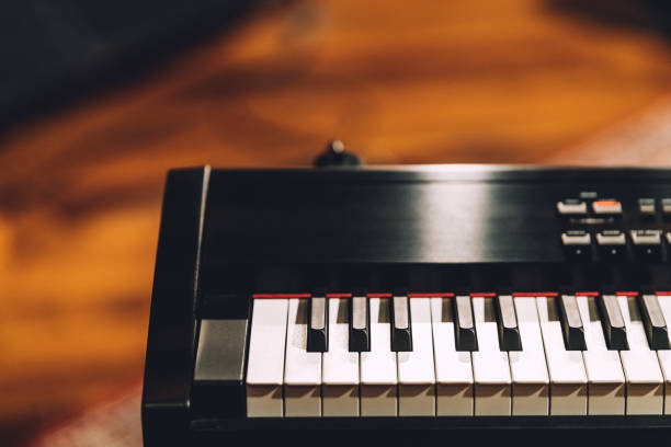 istock Electronic musical keyboard synthesizer with white and black keys in recording studio. With copy space. 1098393400