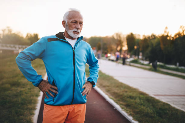 istock Exhausted senior man after a running session outdoors 1098397100