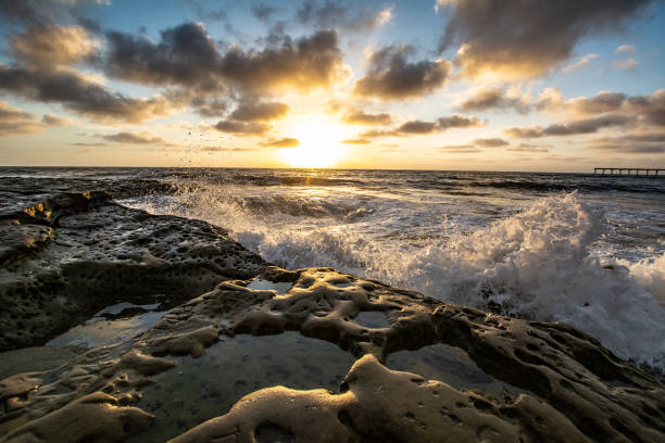 Rocky Pacific Ocean coastline at dusk with clouds