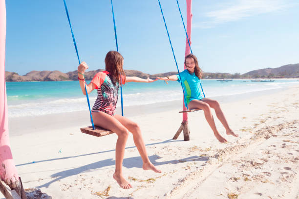 istock Happy little girls on swings 1098399994