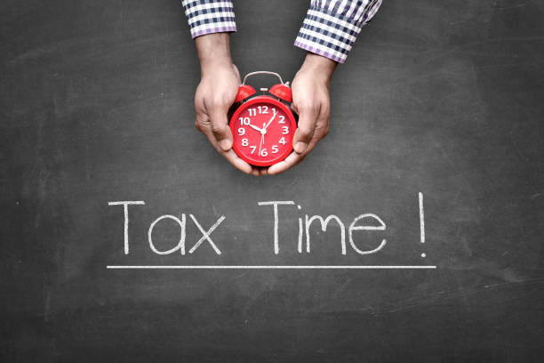 1040 form with sticker tax time, calculator and pen, deadline april season