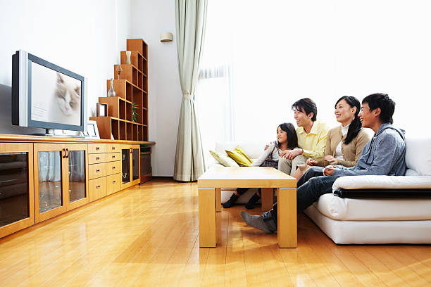 Family watching TV stock photo