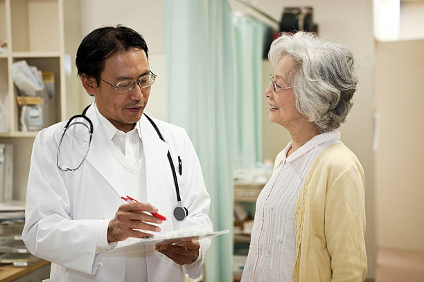 Doctors and old patient Doctors and old patient in hospital. japanese doctor and patient stock pictures, royalty-free photos & images