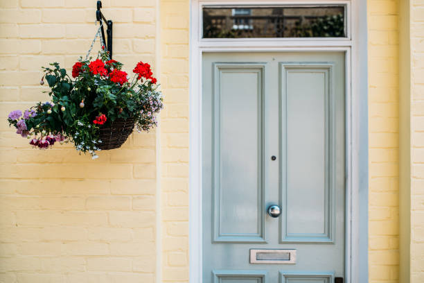 istock Beautiful yellow house facade with flowers hanging 1098407734